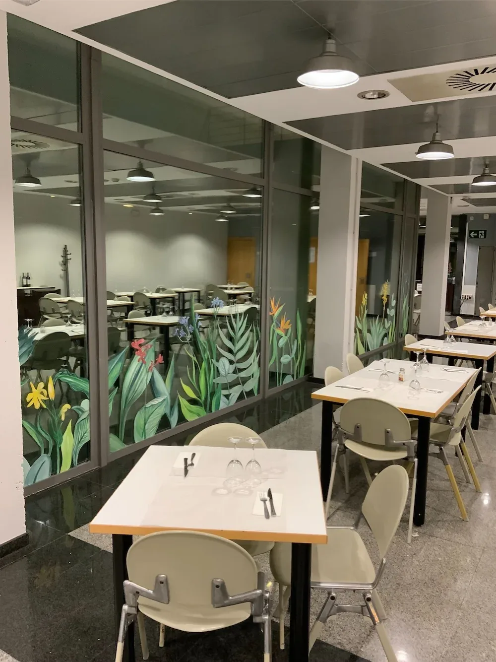 Mural botánico pintado sobre cristal en comedor de restaurante